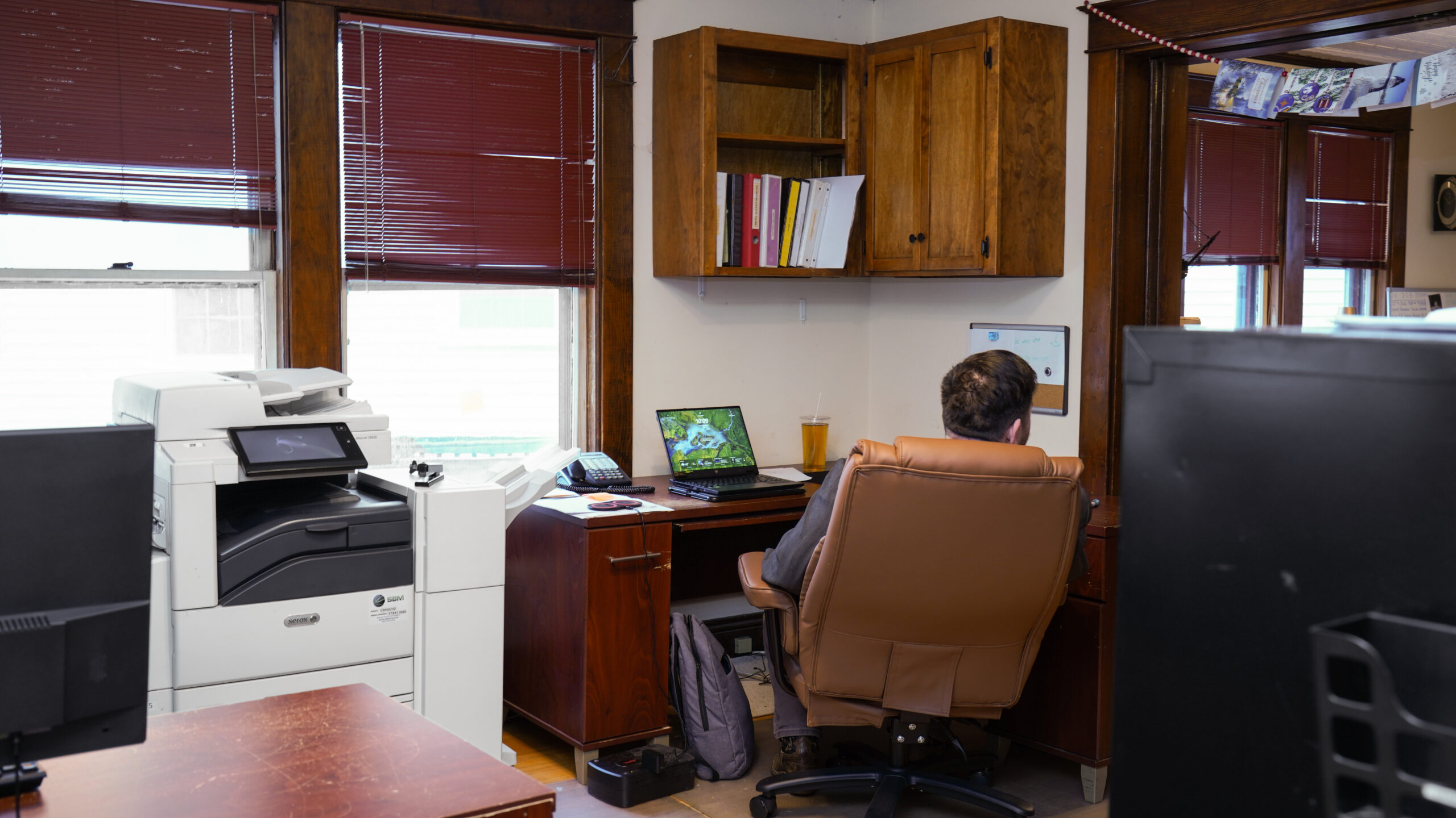 A diverse group of four professionals collaborating at a desk in a modern office.