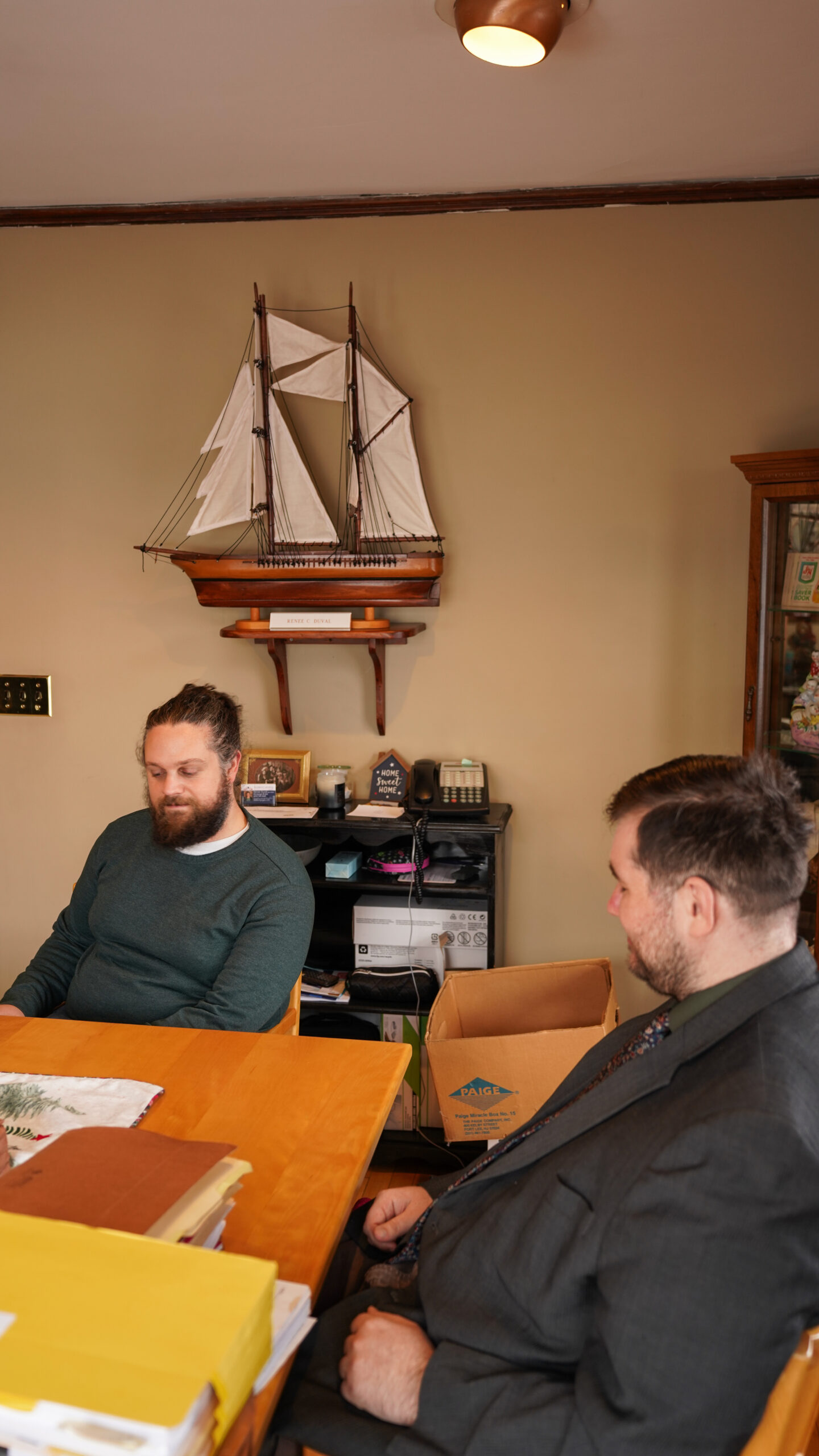 A diverse group of four professionals collaborating at a desk in a modern office.