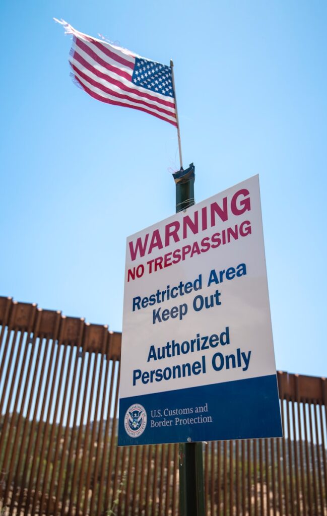 a sign warning of trespassing and restricted area at an ICE detention facility